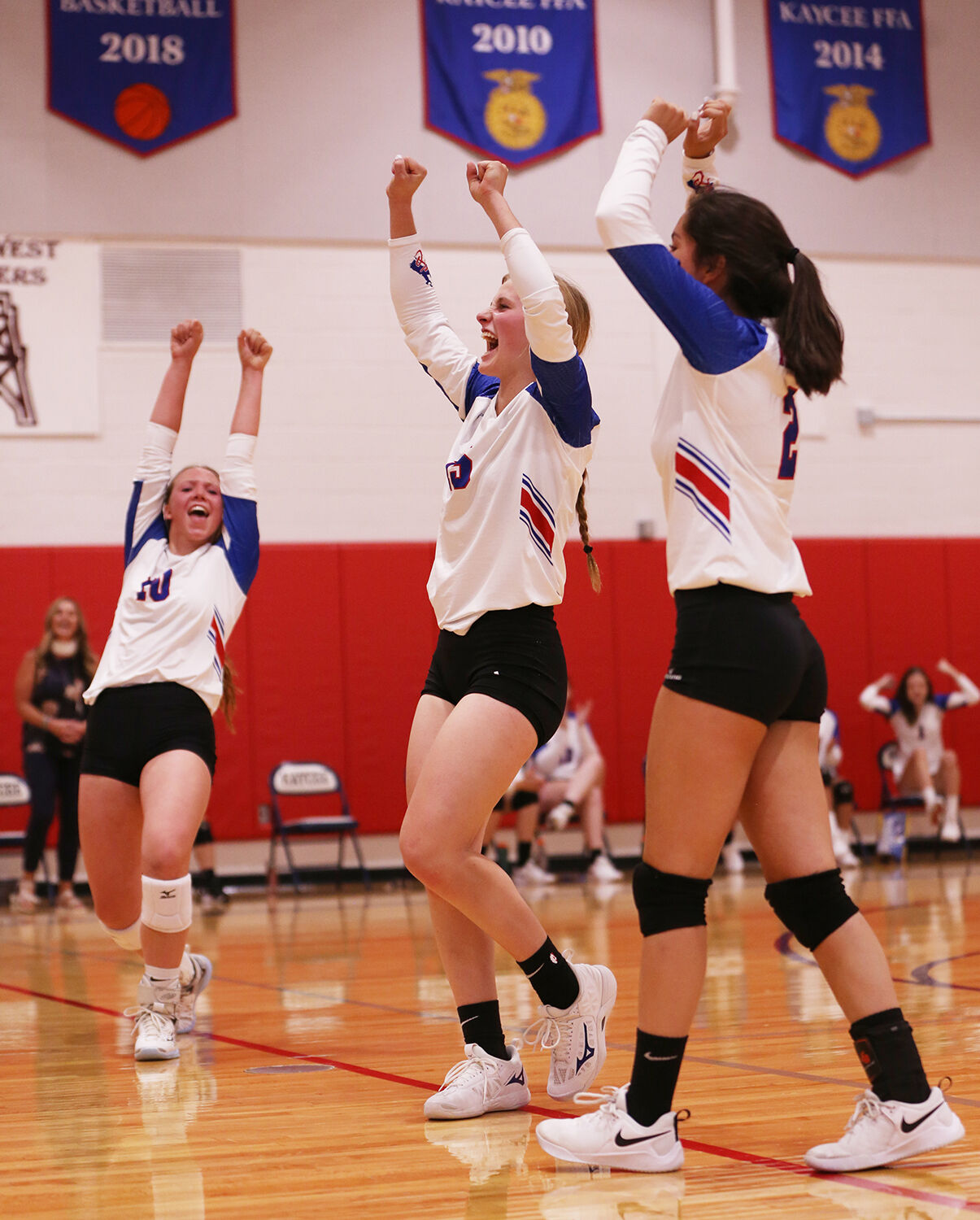Sierra Kilts, Tinley Pierson and Jackie Ramirez throw their hands up into the air